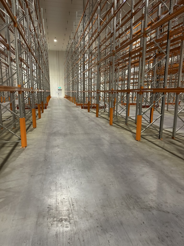 Empty warehouse racking system with metal shelving and safety guards